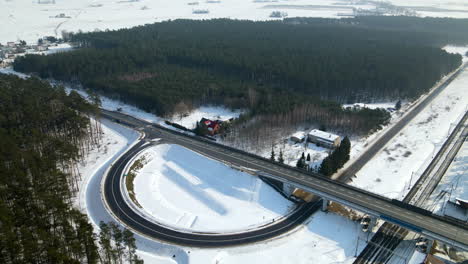 Arc-Asphalt-Road,-Elevated-Guideway,-And-Railway-Track-During-Winter-Near-Racowice,-Poland