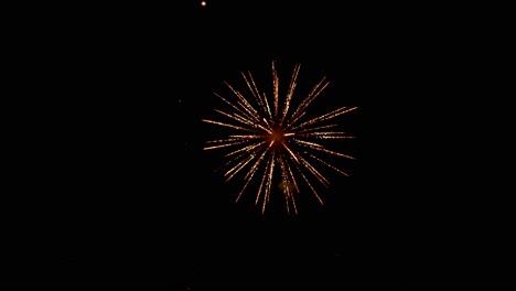 Large-colorful-explosions-of-shimmering-and-sparkling-light-fill-the-black-night-sky-as-fireworks-erupt-during-a-holiday-event-celebration