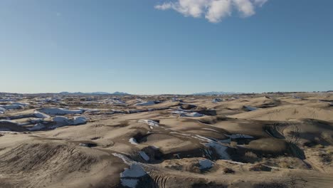 Aerial-forward-over-sand-dunes-on-winter-day,-Little-Sahara-Desert