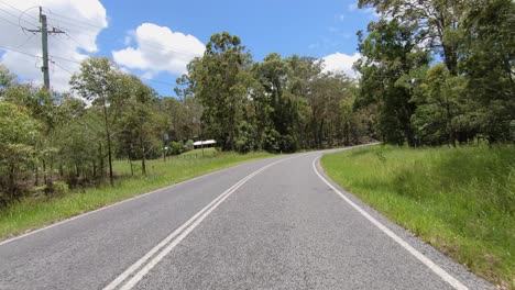 Rear-facing-driving-point-of-view-POV-of-a-deserted-Queensland-country-road-with-telegraph-poles-and-blude-sky---ideal-for-interior-car-scene-green-screen-replacement