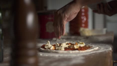 Seasoning-oregano-raw-homemade-cheese-pizza-in-wooden-table-Slow-Motion-60FPS