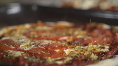 Seasoning-hot-smokey-delicious-homemade-pizza-in-wooden-table-Slow-Motion-60FPS