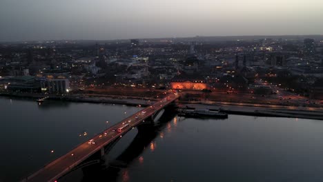 Drone-flight-by-night-over-Mainz-right-after-magic-hour-on-a-warm-spring-day-showing-the-city-of-Biontech-in-the-back