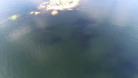 Drone-tilt-of-beautiful-stone-island-in-the-sea