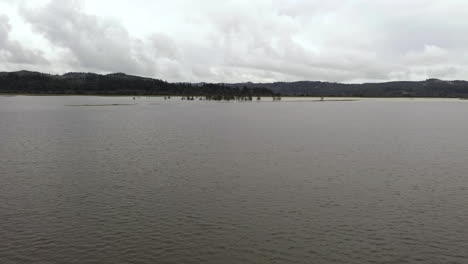 Drone-Fly-Over-Flooded-Foreground-In-Coquille-Valley,-Bandon,-Oregon,-USA