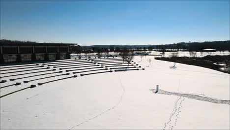 Flying-toward-a-frozen-outdoor-amphitheater-in-the-park-after-a-snow-storm