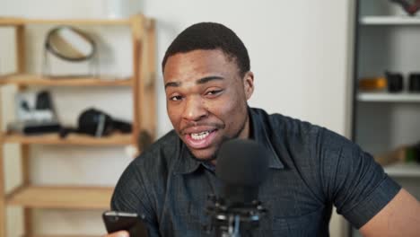 Pleasant-smiling-black-man-communicates-by-voice-online