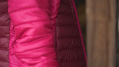 Close-up-of-female-hand-pink-jacket-opening-wooden-house-door-slow-motion-60fps