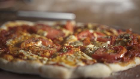 Close-up-of-Delicious-smokey-home-made-pizza-on-a-wooden-table-Slow-Motion-60FPS