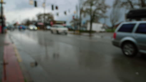 Blurred-City-Traffic,-Cars-Driving-On-Wet-Road-During-Rainy-Day