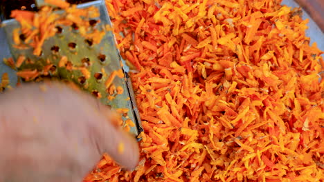 Grating-turmeric-roots-into-shredded-pieces-for-turmeric-powder