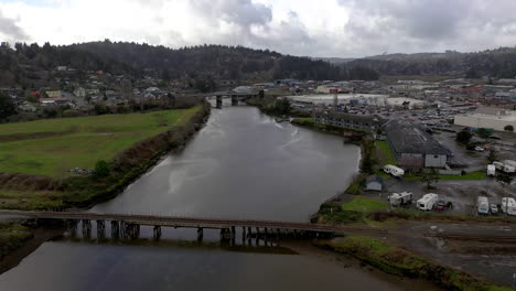 Aerial-flying-over-train-track-bridge-going-over-slough,-Coos-Bay,-Oregon