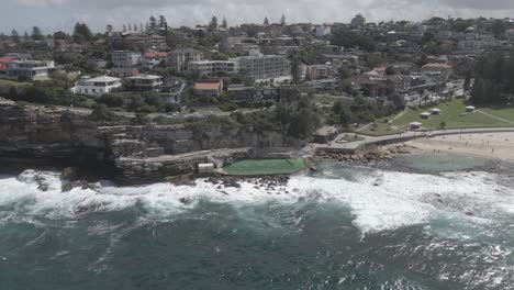 Aerial-View-Of-Bronte-Rock-Pool-With-Bronte-Residential-At-The-Back-In-Bronte-Beach,-Eastern-Suburbs,-Sydney,-New-South-Wales,-Australia---drone-shot