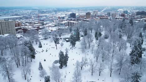 Wright-Park-And-Cityscape-Covered-By-Snow-In-Tacoma,-Washington,-USA---Aerial-Drone-Shot
