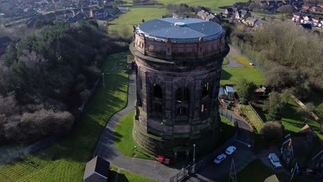 Aerial-view-National-trust-Norton-water-tower-landmark-architecture-Runcorn-England-countryside-scene-descending-tilt-up