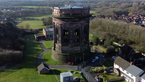 Aerial-view-National-trust-Norton-water-tower-landmark-Runcorn-Victorian-architecture-England-rural-scene-orbit-left