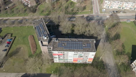 Aerial-of-solar-panels-on-large-apartment-building-rooftop