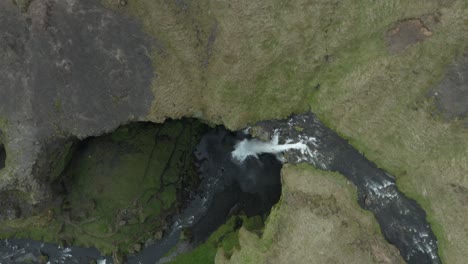 Aerial-at-Kvernufoss-waterfall-rising-above-scenic-volcanic-canyon,-Iceland