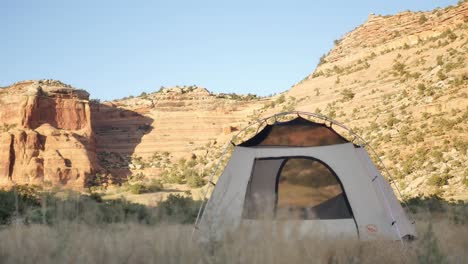 White-Tent-with-Black-Rocks-Canyon-in-Background,-Static-Shot-with-Copy-Space