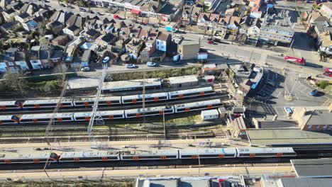 Chingford-overground-station-train-leaves-,East-London-UK-Aerial-footage-