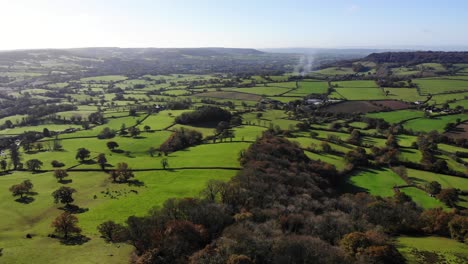 Aerial-panning-left-shot-from-Dumpdon-Hill-looking-down-the-Otter-Valley-towards-Honiton-and-Dartmoor-Devon-England-UK