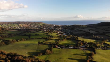 Aerial-forward-moving-shot-from-Firebeacon-Hill-looking-towards-Sidmouth-and-Lyme-Bay-Devon-England-UK