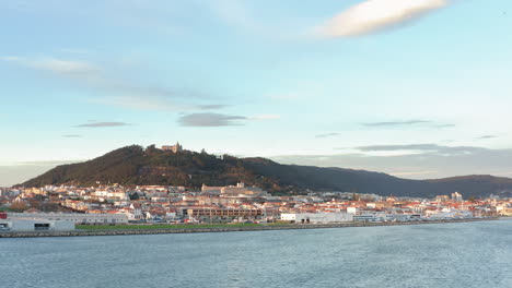 View-to-Viana-do-Castelo-cityscape-over-the-Lima-river-waterfront---Aerial-wide-slide-tracking-shot