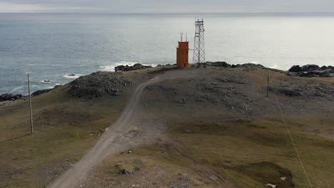 Aerial-of-Hvalnes-Lighthouse-on-wild-shore-of-Iceland,-Atlantic-Ocean