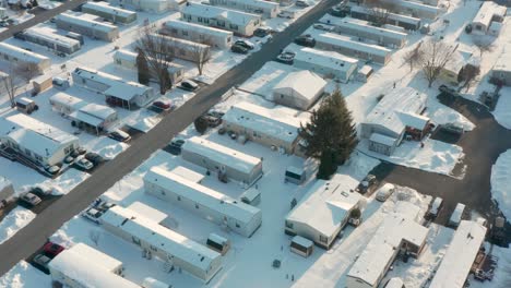 Aerial-tilt-up-of-mobile-homes-in-Appalachia,-winter-snow