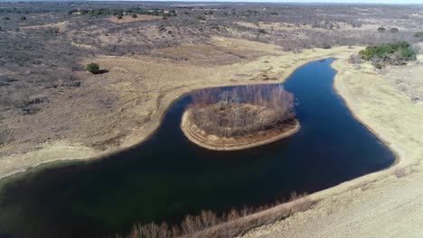 Aerial-drone-flight-over-pond-and-island-near-Richland-Springs-Texas
