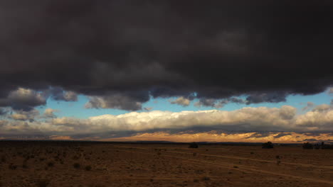 Bedrohliche-Dunkle-Wolken-Füllen-Den-Himmel-Kurz-Vor-Einem-Heftigen-Wolkenbruch-In-Der-Mojave-Wüste---Gleitende-Luftaufnahme