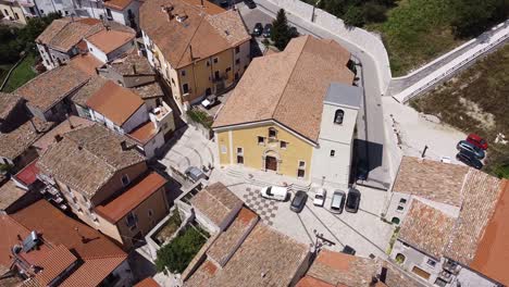 Aerial-landscape-view-above-Pietraroja's-church,-in-a-italian-hilltop-village