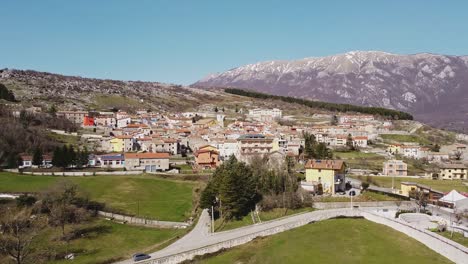 Aerial-panoramic-landscape-view-of-Pietraroja,-an-italian-village-on-top-of-a-hill,-on-a-bright-sunny-day