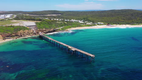 Catherine-Hill-Bay-pier-on-New-South-Wales-Australia-coast,-aerial-view