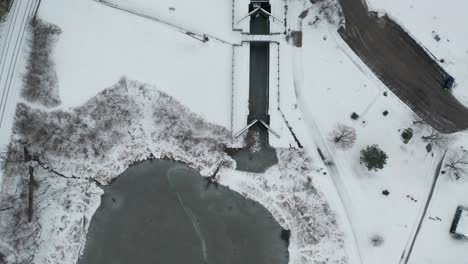 Top-down-aerial-view-of-frozen-sluice-during-winter-season