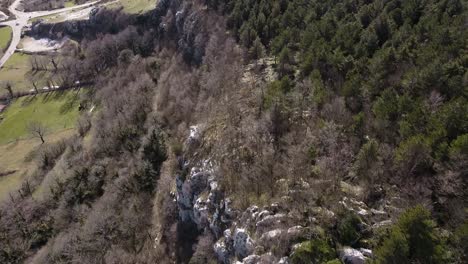 Aerial-view-above-a-green-forest-on-the-rocky-Apennine-mountains,-Italy