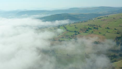 Aerial-shot-dollying-back-across-a-cloud-covered-pastoral-landscape