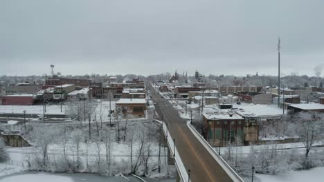 Bridge-over-frozen-river-and-small-American-county-town-in-aerial-view
