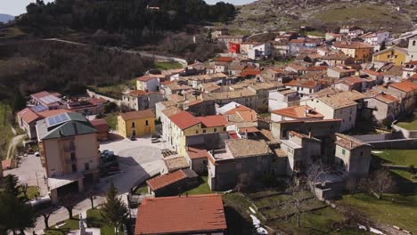 Aerial-view-over-Pietraroja,-an-italian-village-on-top-of-a-hill,-on-a-bright-sunny-day