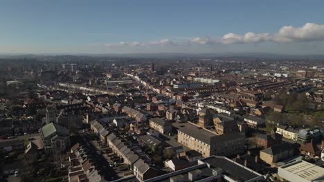 4K-aerial-panoramic-view-of-taunton-Somerset,-United-Kingdom,-drone-moving-to-the-right-showing-the-blue-sky-with-some-clouds