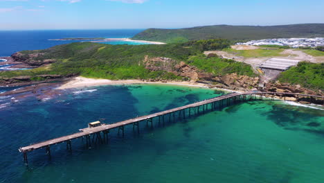 Beautiful-pier-on-Australian-coast,-Catherine-Hill-Bay,-aerial-view