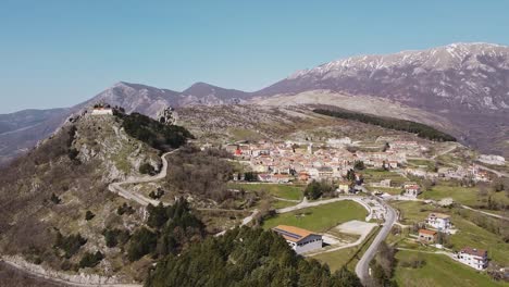 Aerial-panoramic-landscape-view-of-Pietraroja,-a-hill-top-village-in-Italy,-in-the-Apennines