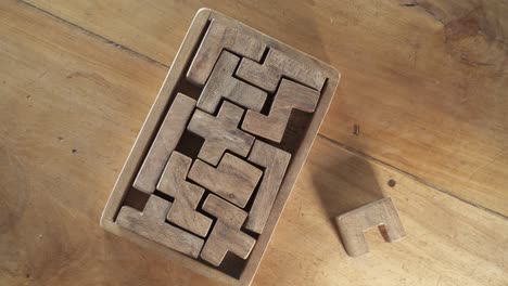 Game-of-wits-with-a-puzzle-piece-on-a-wooden-table-not-fitting-in