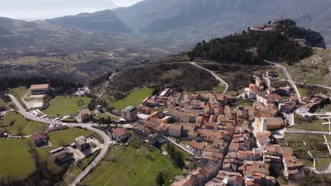 Aerial-view-above-Pietraroja,-an-italian-village-on-a-hill-top,-on-a-sunny-day