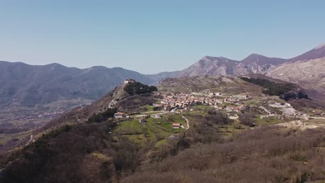 Aerial-landscape-view-of-Pietraroja,-a-village-in-Italy,-on-top-of-a-hill,-in-the-Apennines