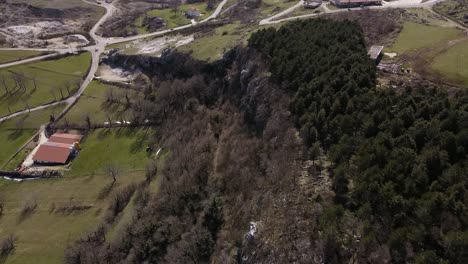 Aerial-view-above-country-roads-and-green-forest-on-the-rocky-Apennine-mountains,-Italy