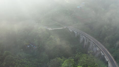 Aerial-footage-of-9-arch-bridge-during-the-misty-morning-in-Ella,-Sri-Lanka