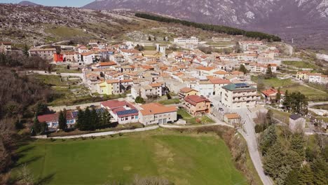 Aerial-landscape-view-of-Pietraroja,-a-village-on-top-of-a-hill,-in-Italy,-on-a-sunny-day