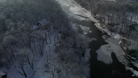 Moody-forest-cabin-high-angle-view-revealing-beautiful-horizon-and-frosty-river
