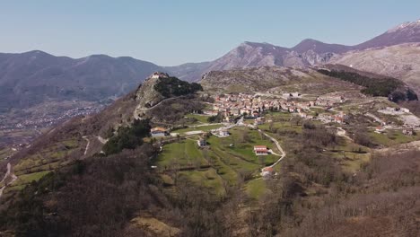 Aerial-landscape-view-of-Pietraroja,-a-village-on-top-of-a-hill,-in-the-Apennines,-Italy